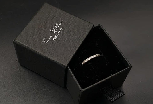 Silver band ring with bark design